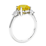 3 stone wedding ring featuring round yellow canary diamond looking yellow sapphire center diamond and matching sides set in 14k white gold.