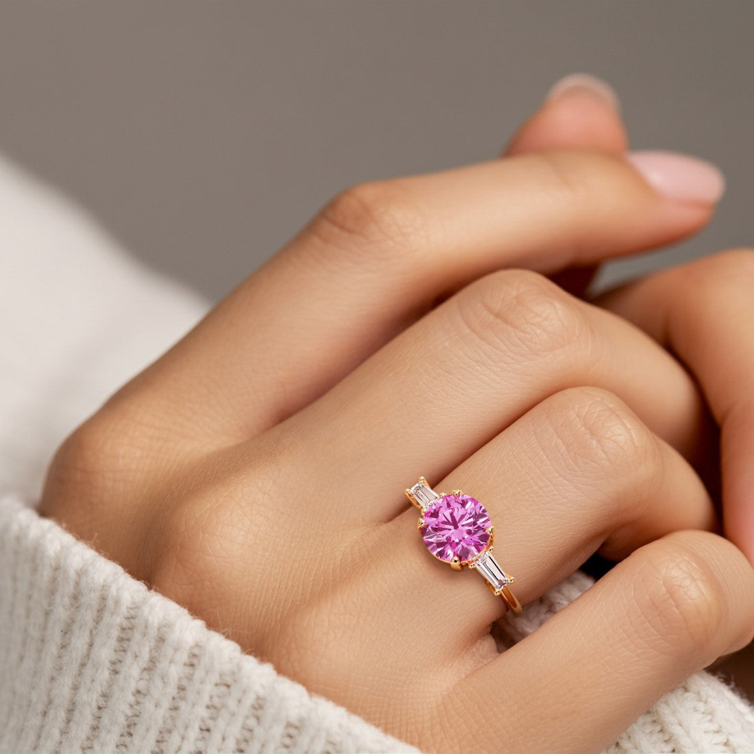 Woman wearing handcrafted round center gemstone engagement ring with sparkling diamond sides.