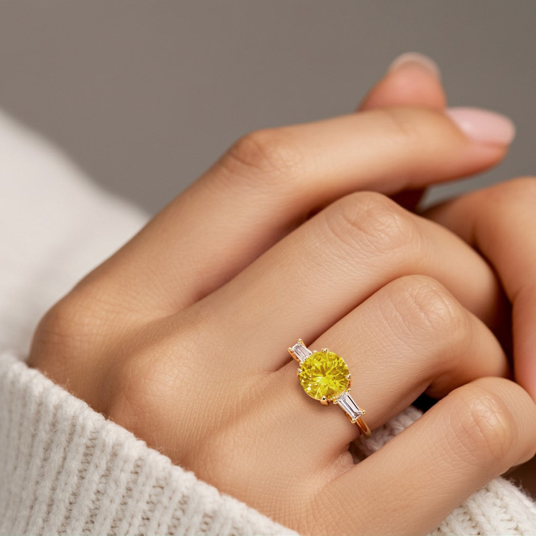 Woman wearing handcrafted round center gemstone engagement ring with sparkling diamond sides.