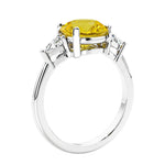 Round fancy yellow diamond alternative yellow sapphire 3 stone engagement ring in white gold—a refined and popular choice among lab grown engagement rings.