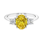 Three stone oval cut real yellow sapphire and diamond ring in classic design.