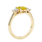 3 stone wedding ring with oval center gemstone and diamond side stones.