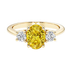 Oval 3 stone engagement ring with fancy yellow diamond look yellow sapphire and brilliant diamond side stones.