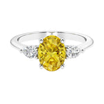 Three stone oval and pear shaped real yellow sapphire and diamond ring in classic design.