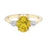 Oval and pear shape 3 stone engagement ring with fancy yellow diamond look yellow sapphire and brilliant diamond side stones.