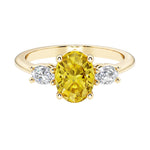 Oval cut three stone diamond engagement ring with romantic charm with gemstone center 14k yellow gold