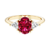 Oval cut three stone diamond engagement ring with romantic charm with red gemstone center 14k yellow gold