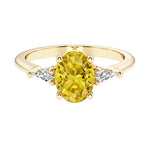 Oval cut three stone yellow diamond gemstone engagement ring with diamonds set yellow gold.