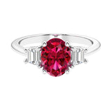 Oval cut three stone diamond engagement ring with romantic charm.