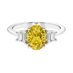 Oval cut three stone diamond engagement ring with romantic charm.