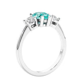 3 stone diamond engagement ring with pear shaped center in white gold featuring Paraiba Green Tourmaline.