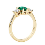 Green Emerald three stone pear shaped engagement ring with classic styling.