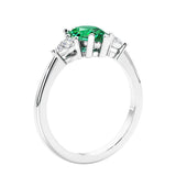 3 stone diamond engagement ring with pear shaped center in white gold featuring Green Emerald.