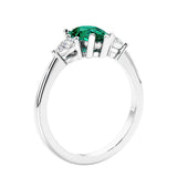 3 stone diamond engagement ring with pear shaped center in white gold featuring Green Emerald.
