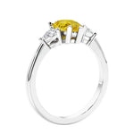 3 stone diamond engagement ring with pear shaped center in white gold featuring Yellow Sapphire.
