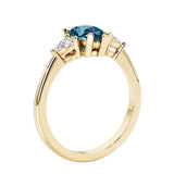 Color changing alexandrite three stone pear shaped engagement ring with classic styling.