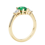 Green Emerald three stone pear shaped engagement ring with classic styling.