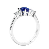 3 stone diamond engagement ring with pear shaped center in white gold featuring Blue Gemstone.