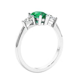 3 stone diamond engagement ring with pear shaped center in white gold featuring Green Gemstone.