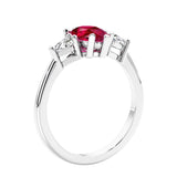 3 stone diamond engagement ring with pear shaped center in white gold featuring Red Gemstone.