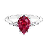 Red Gemstone 3 stone pear diamond ring set in a delicate band.