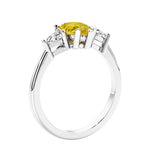 3 stone diamond engagement ring with pear shaped center in white gold featuring Yellow Gemstone.