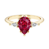 Red Gemstone pear shaped 3 stone engagement ring with elegant diamond side stones.