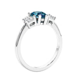 3 stone diamond engagement ring with pear shaped center in white gold featuring Alexandrite.