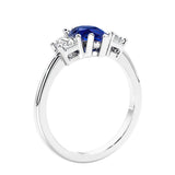 3 stone diamond engagement ring with pear shaped center in white gold featuring Blue Gemstone.