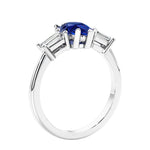 3 stone diamond engagement ring with pear shaped center in white gold featuring Blue Gemstone.