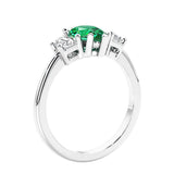 3 stone diamond engagement ring with pear shaped center in white gold featuring Colombian Green Emerald.