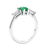 3 stone diamond engagement ring with pear shaped center in white gold featuring Colombian Green Emerald.