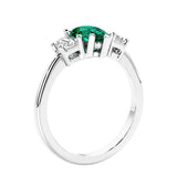3 stone diamond engagement ring with pear shaped center in white gold featuring Green Emerald.