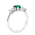 3 stone diamond engagement ring with pear shaped center in white gold featuring Green Emerald.