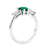 3 stone diamond engagement ring with pear shaped center in white gold featuring Green Emerald.