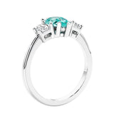 3 stone diamond engagement ring with pear shaped center in white gold featuring Paraiba Tourmaline.
