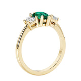 Green Emerald three stone pear shaped engagement ring with classic styling.