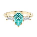 Paraiba Tourmaline pear shaped 3 stone engagement ring with elegant diamond side stones.