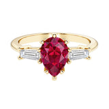 Ruby pear shaped 3 stone engagement ring with elegant diamond side stones.