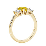 Yellow diamond three stone pear shaped engagement ring with classic styling.