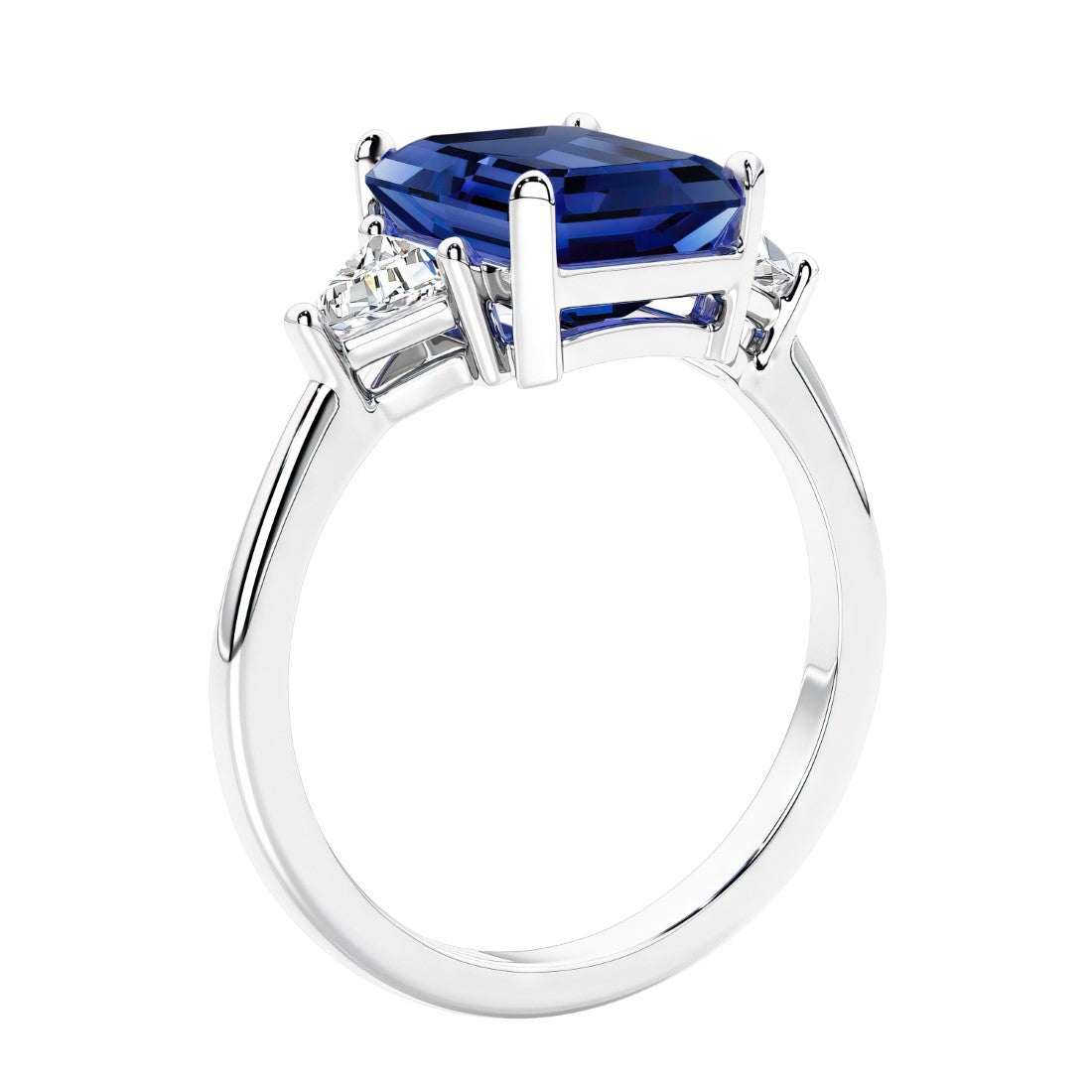 3 stone emerald cut diamond ring in modern gold setting with blue gemstone center.