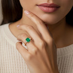 Woman wearing emerald cut three stone engagement ring with bold lines.