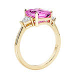 Emerald cut 3 diamond ring representing past, present, and future featuring pink gemstone center.