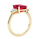 Emerald cut 3 diamond ring representing past, present, and future featuring red gemstone center.