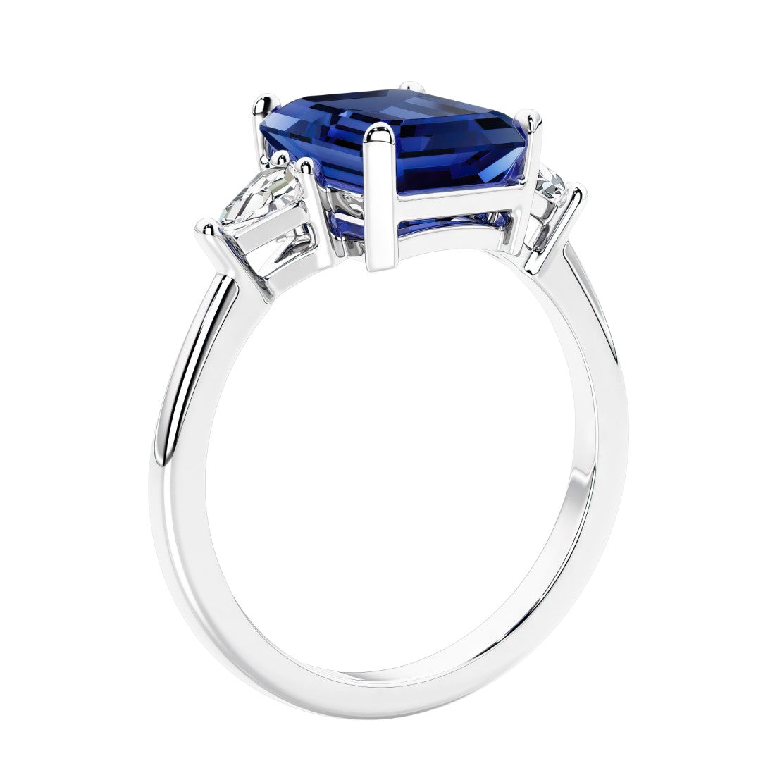 3 stone emerald cut diamond ring in modern gold setting with blue gemstone center.