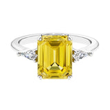 Three stone emerald cut engagement ring for timeless elegance featuring pink gemstone and diamonds.