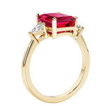 Emerald cut 3 diamond ring representing past, present, and future featuring red gemstone center.