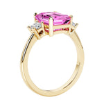 Emerald cut 3 diamond ring representing past, present, and future featuring pink gemstone center.