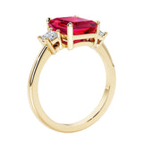 Emerald cut 3 diamond ring representing past, present, and future featuring red gemstone center.