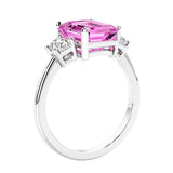 3 stone emerald cut diamond ring in modern gold setting with pink gemstone center.